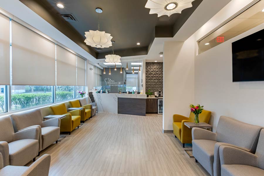 Front desk and lobby with lounge chairs at Glen Perio in Glenview, IL