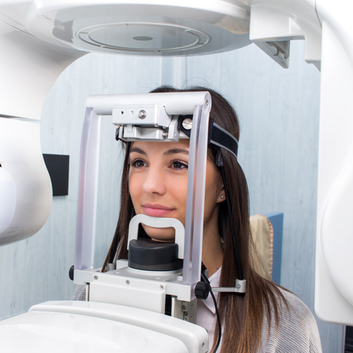 Smiling patient getting a scan with advanced technology.