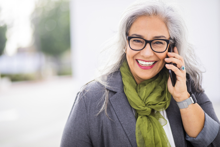 A smiling patient contacting Glen Perio on a cell phone.