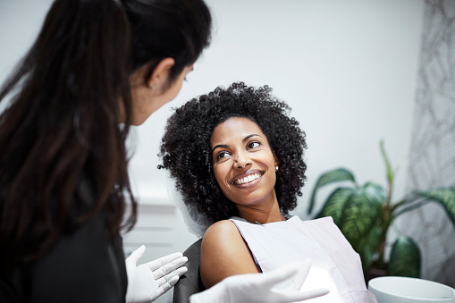 Image of a smiling woman after finding out her dental care is affordable at Glen Perio in Glenview, IL.