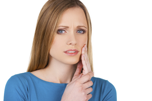 Image of a young woman with gum disease pain, at Glen Perio in Glenview, IL.
